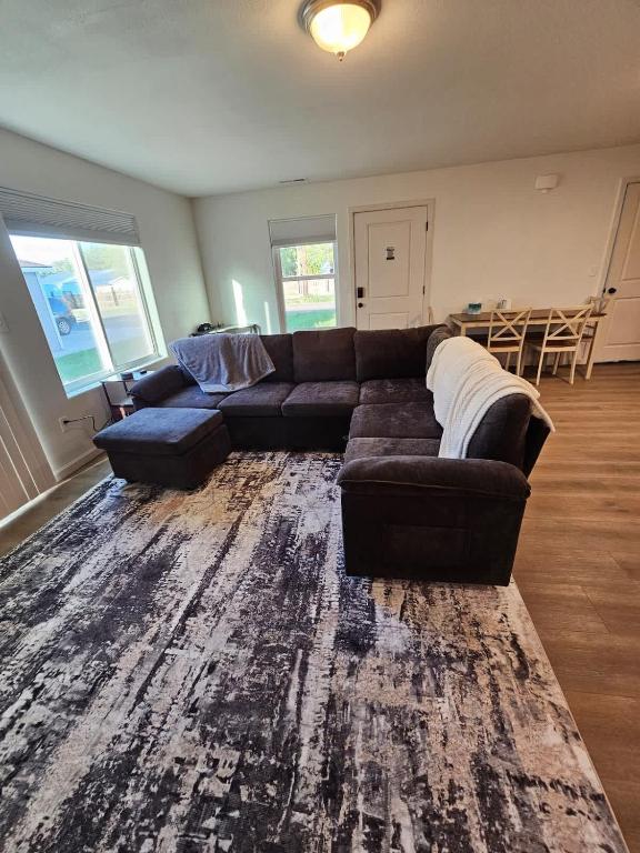 a living room with a couch and a rug at Southern Charm on Earl in Stanfield