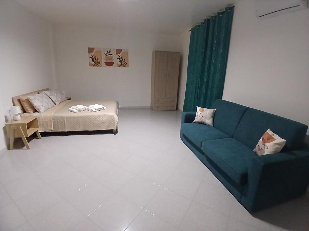a living room with a couch and a bed at Dolcecasa in Misilmeri