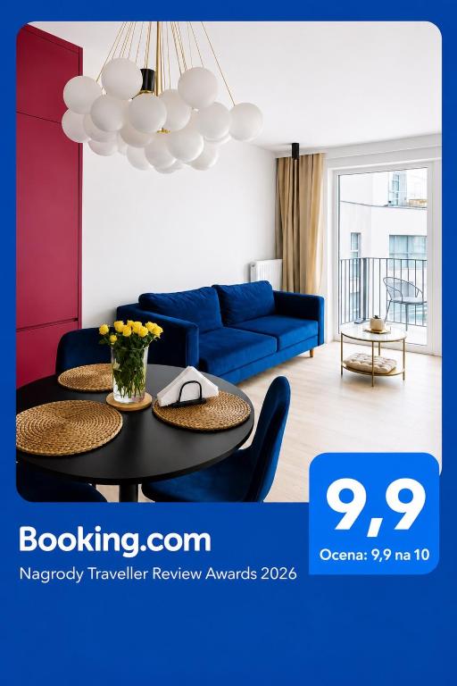 a living room with a blue couch and a table at Penthouse21 in Oświęcim