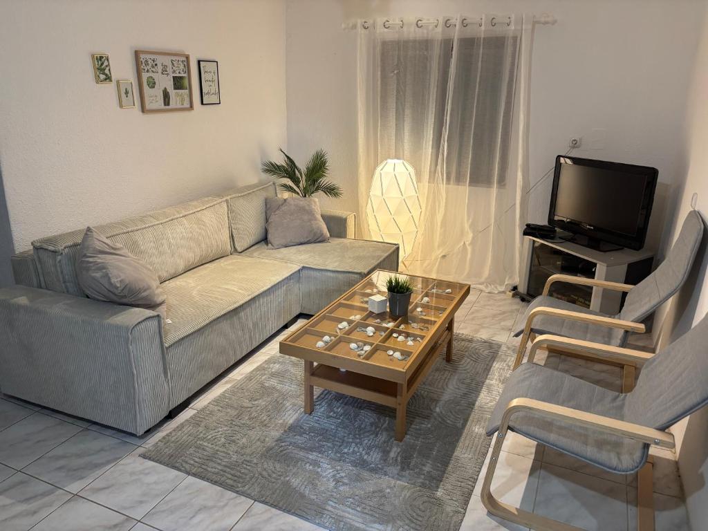 a living room with a couch and a coffee table at Chata Domaša - Monika in Holčíkovce