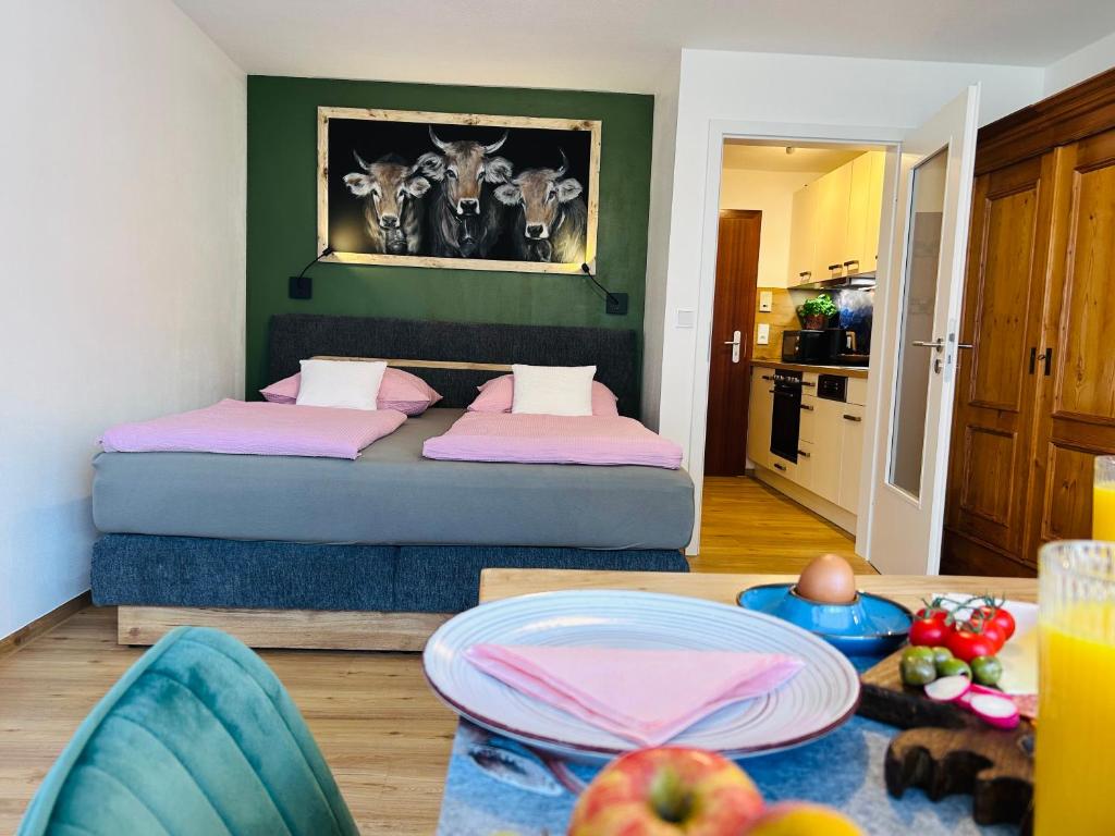 a bedroom with two beds and a table with fruits on it at Ferienwohnungen Boxler in Oberstdorf