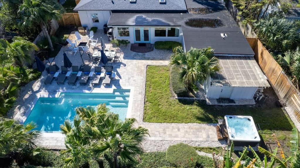 an aerial view of a house with a swimming pool at Poolside Palms - Team Joseph Ellen in Jacksonville Beach