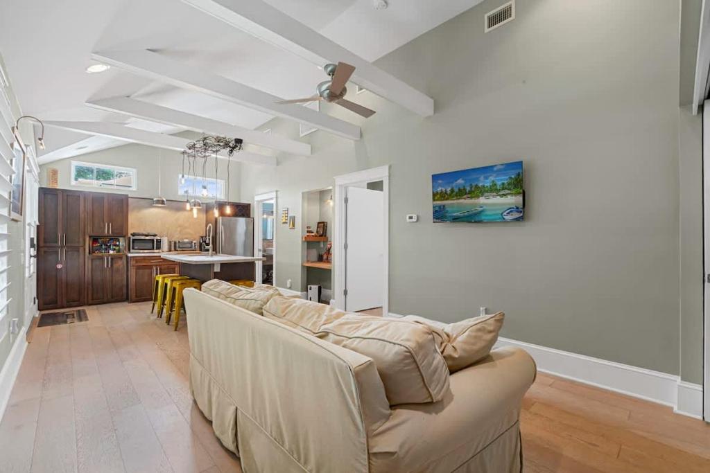 a living room with a couch and a kitchen at Riberia Columbus Cottage - Team Joseph Ellen in St. Augustine