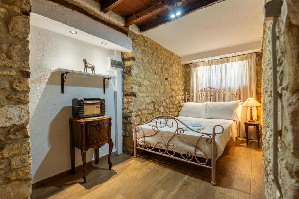 a bedroom with a bed and a tv in a room at Stefanos House in Afitos