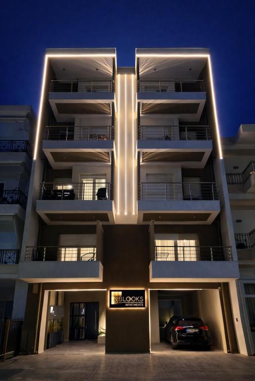a building with a car parked in front of it at 8 Blocks Apartments - Alexandroupoli in Alexandroupoli