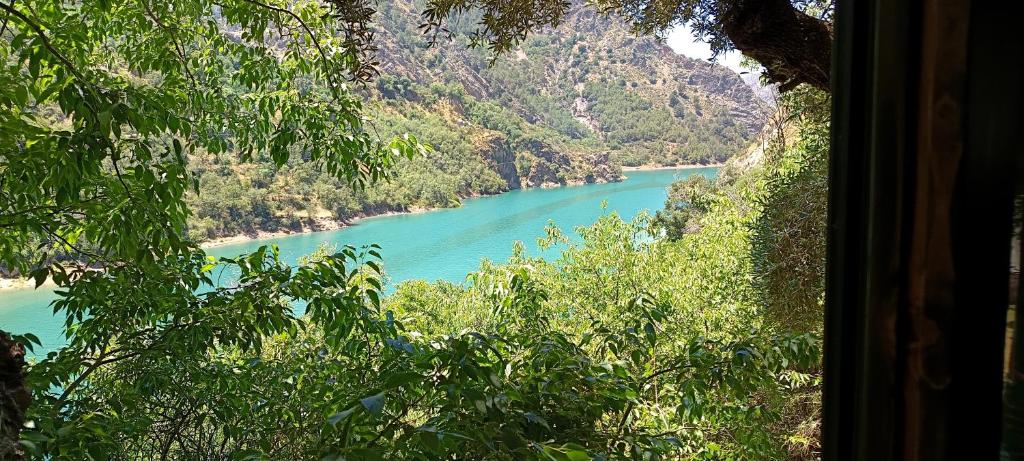 a view of a river from a window at Comfortable lakeside house! in Güéjar-Sierra