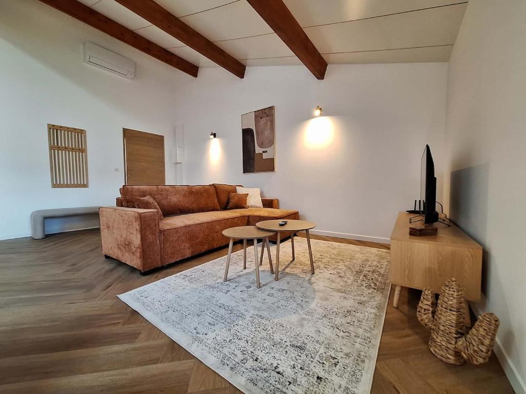a living room with a couch and a table at Les Gites de la Bastide in Ribes
