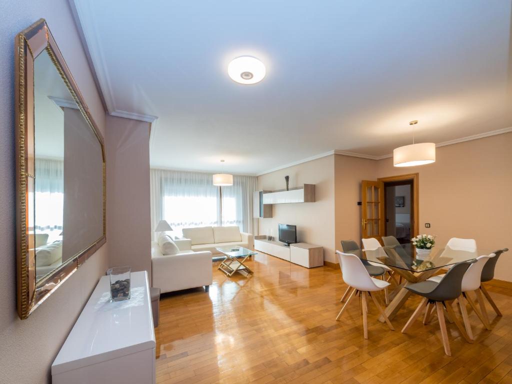 a living room with a table and a dining room at Gestión de Alojamientos Apartments in Pamplona