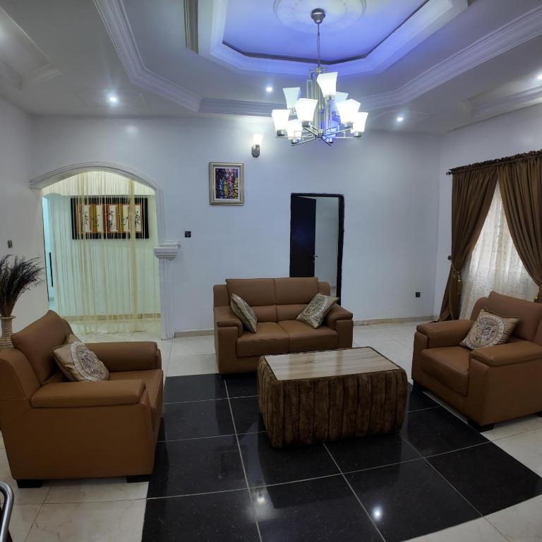 a living room with two couches and a coffee table at Shana Homes in Karsana