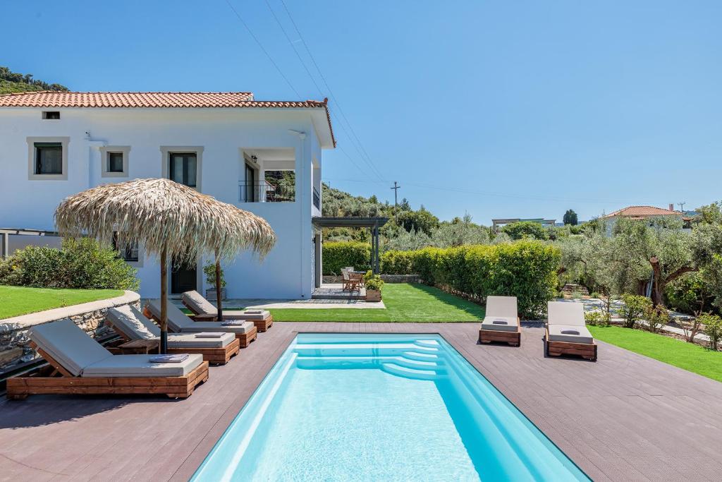 a villa with a swimming pool and a house at Marani Villas Collection in Skopelos Town