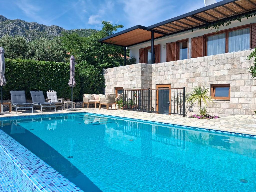 a swimming pool in front of a house at Villa Casa Belvedere near Dubrovnik in Gruda