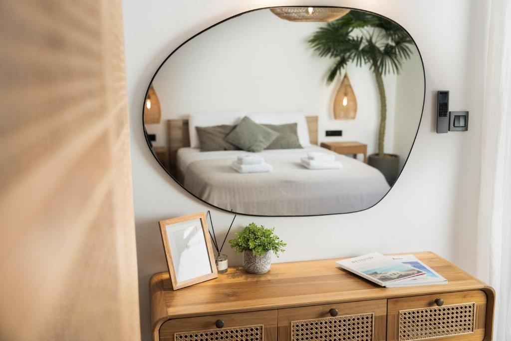 a bedroom with a bed and a mirror on a table at Studio Apartment 5, Unique Location - Sea View in Lithakia