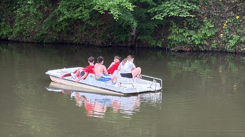 a group of people sitting in a small boat on the water at Filip Cornel in Suciu de Sus