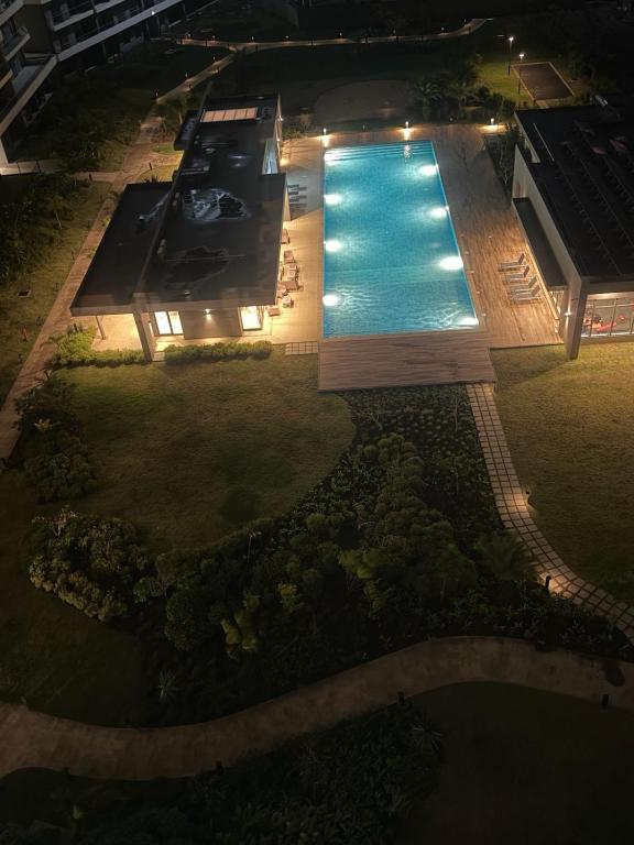 an overhead view of a swimming pool at night at Spacious 2-Bedroom Family Suite with Pool & Garden View in Moka