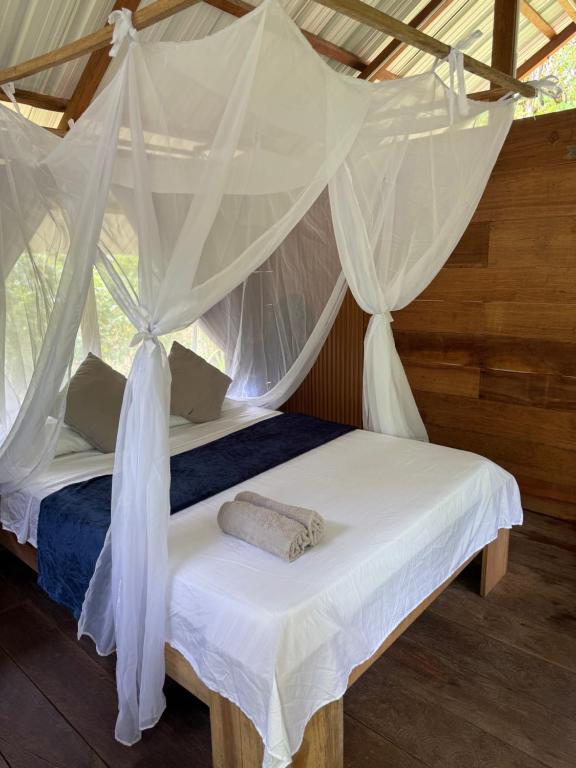 a bedroom with a bed with mosquito netting at Pal Mar in Nuquí