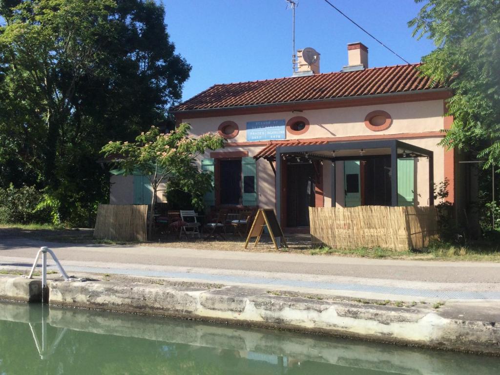 a house next to a body of water at La Maison d'Ecluse No17 - Chambres d'hôtes in Castelsarrasin