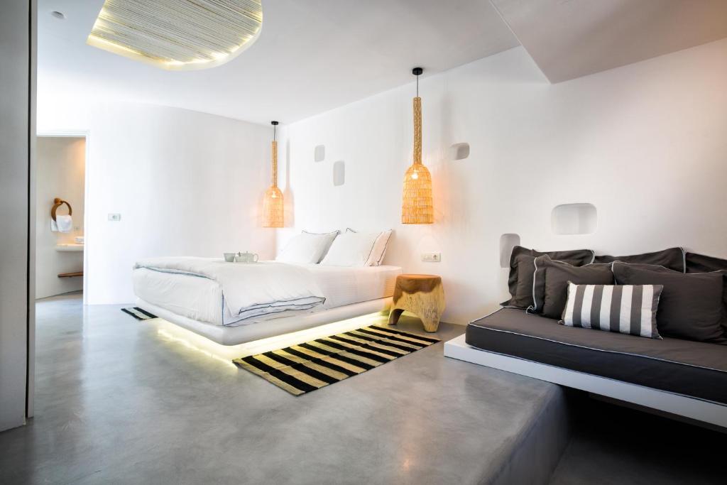 a bedroom with a bed and a couch at Blue Sand Boutique Hotel & Suites in Agali