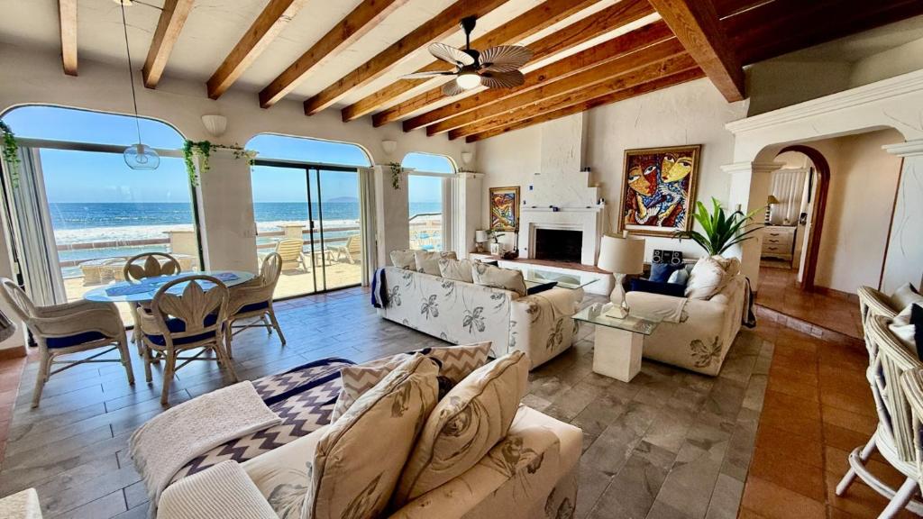 a living room with couches and a table and chairs at Baja Del Mar 47 in Rosarito Beach