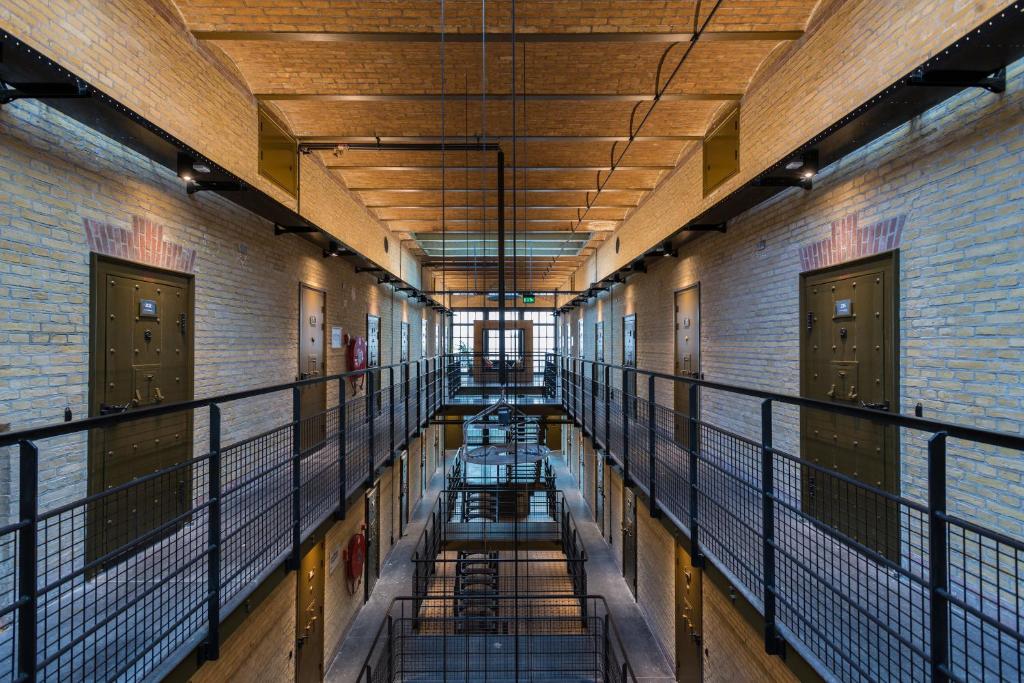 an empty hallway in a building with water on the floor at Alibi Hostel Leeuwarden in Leeuwarden