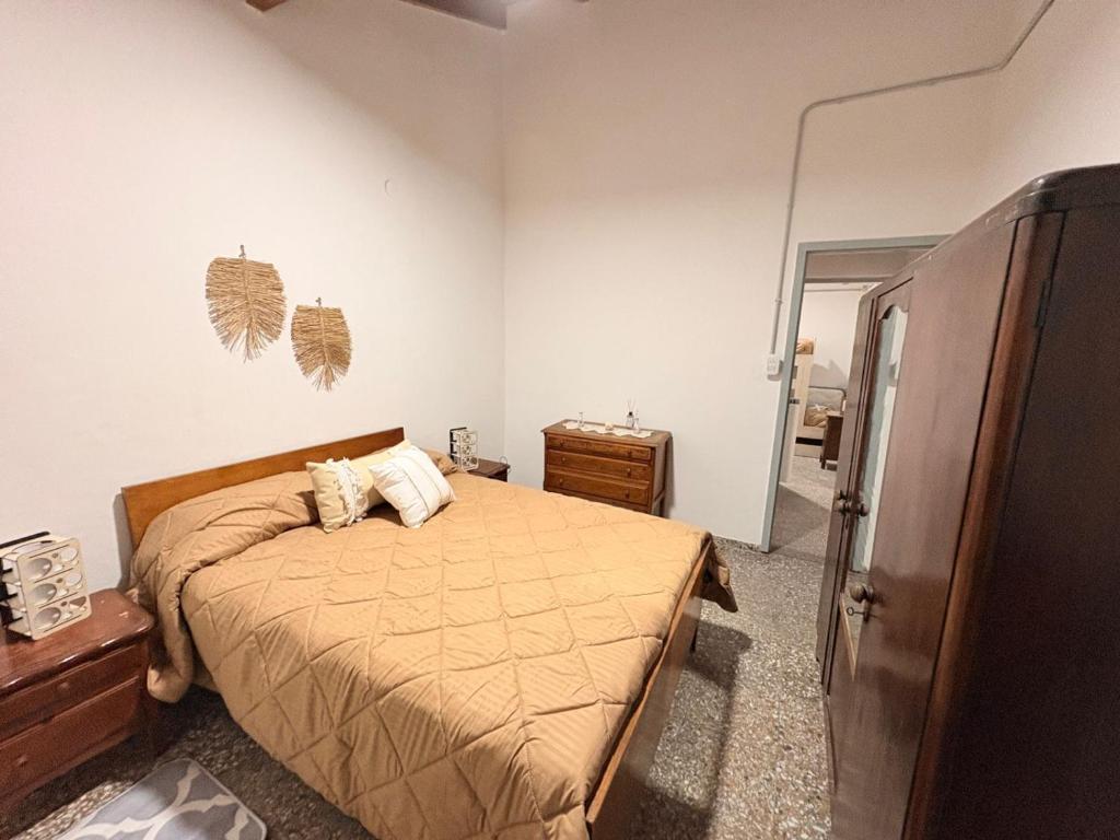 a bedroom with a bed and a dresser and a mirror at Villa Valeria in General Acha