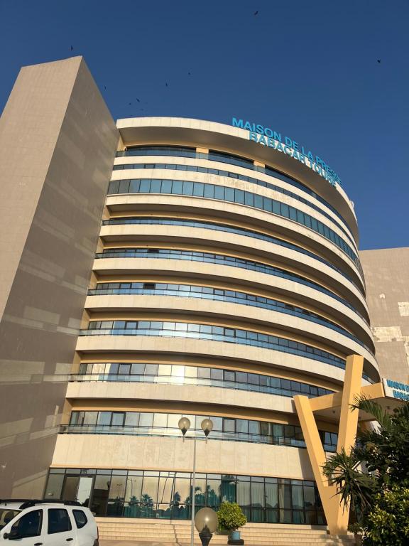a building with a car parked in front of it at Maison Babacar TOURE in Dakar