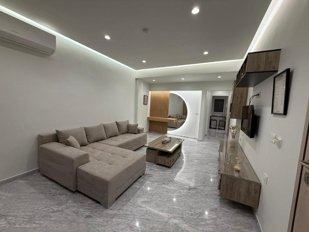 a living room with a couch and a table at Meraki Luxury Retreat in Kos