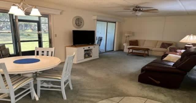 a living room with a table and a couch at Serene Florida Oasis in Inverness