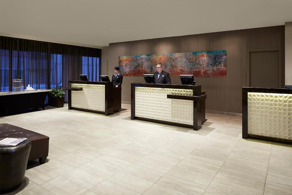 two men in suits sitting at their desks in a lobby at The Barrington Hotel in Halifax