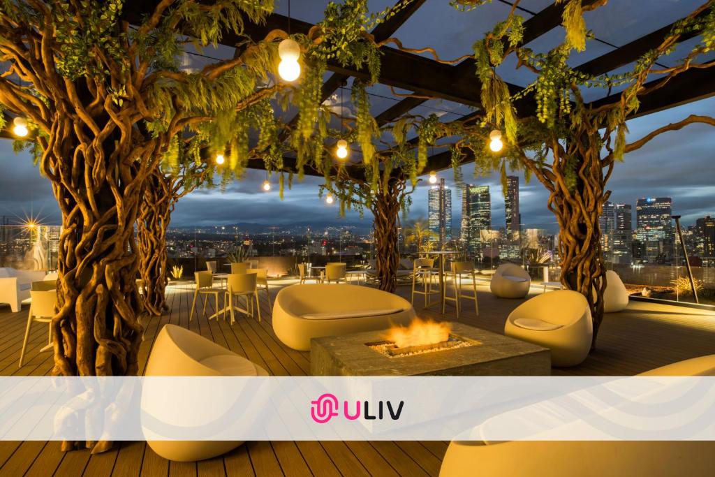 a rooftop restaurant with a view of the city at ULIV Mexico City in Mexico City