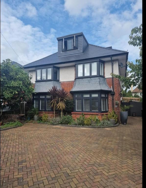 a large house with a brick driveway at Double rooms in shared house in Bournemouth