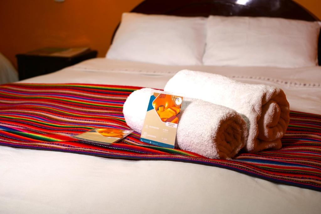 a towel animal sitting on top of a bed at Hotel Margarita in Puno