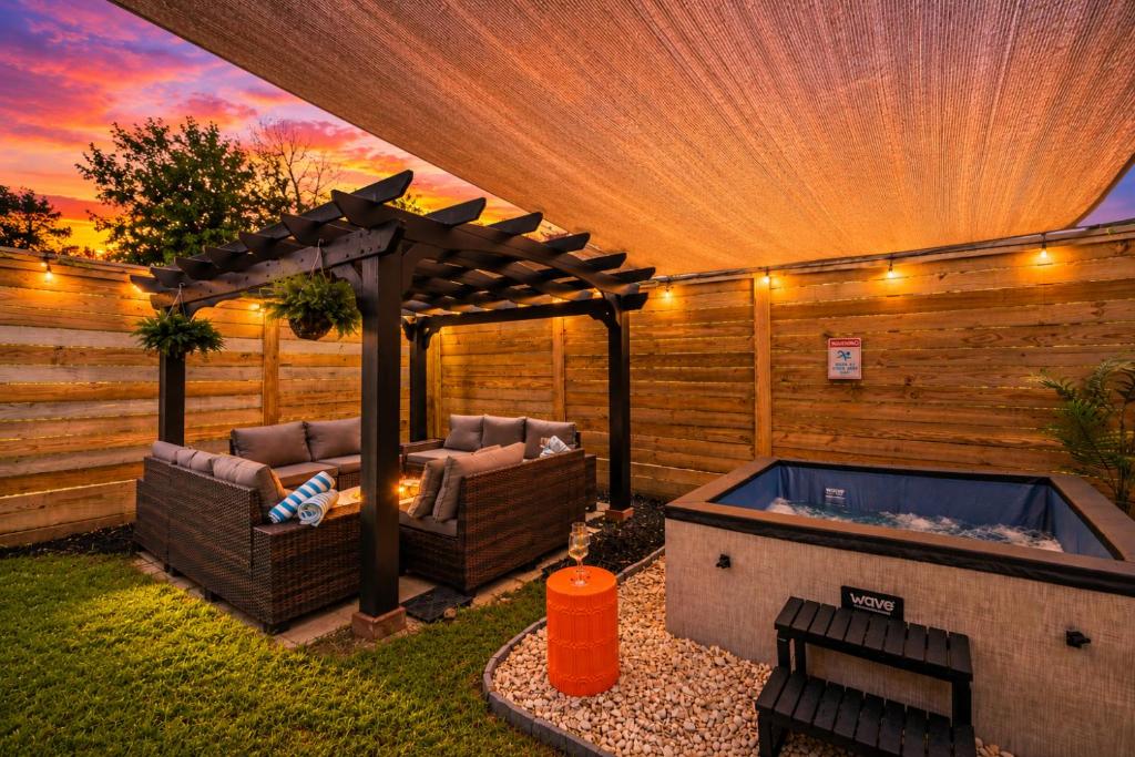 a backyard with a hot tub and a pergola at Downtown Luxe Retreat - King Bed, Pool, Pong, Billiards, Grill & FREE Coffee in Houston