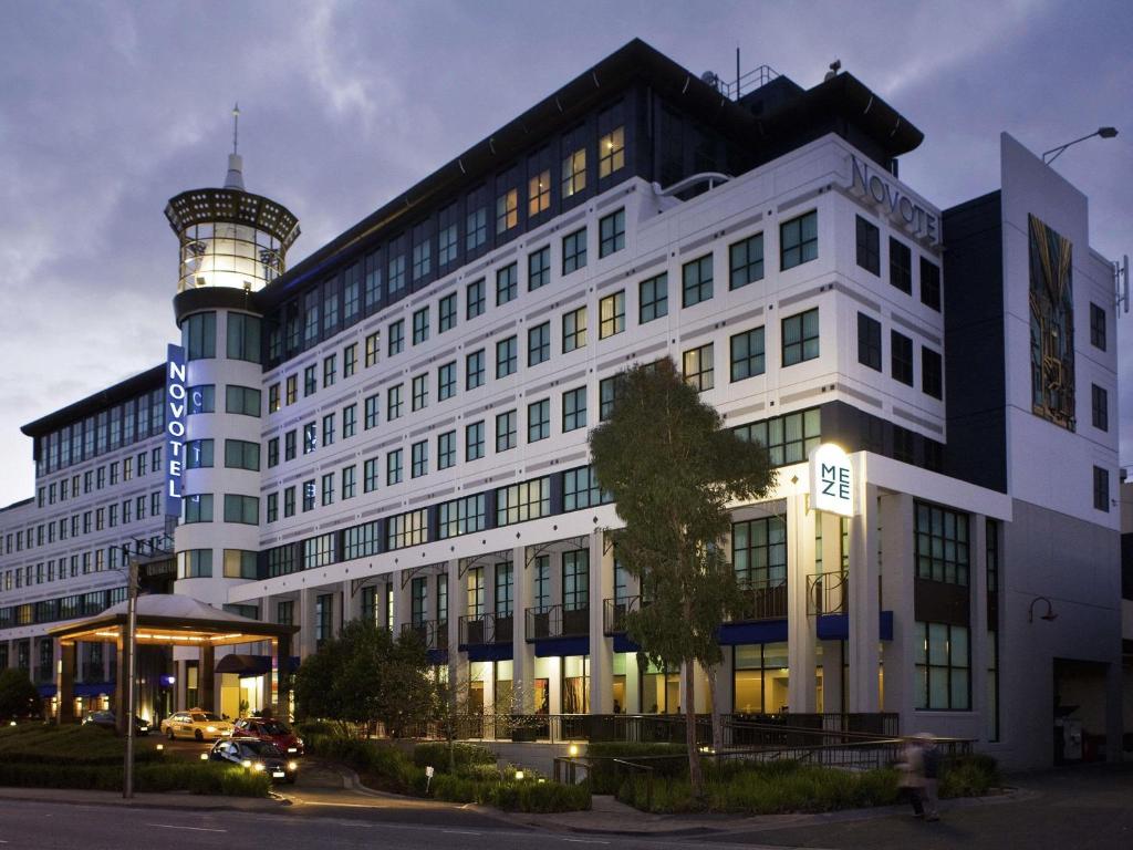 a building with a water tower on top of it at Novotel Melbourne Glen Waverley in Glen Waverley