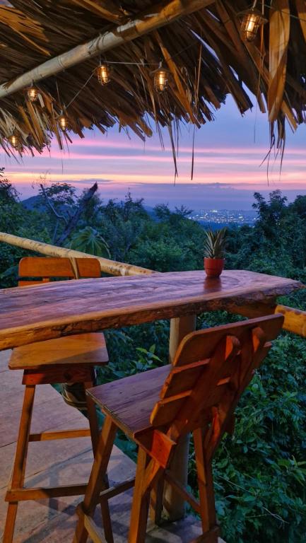 a wooden table with a potted plant on top at Ecologic Mountain Cabin, amazing view in Santa Marta
