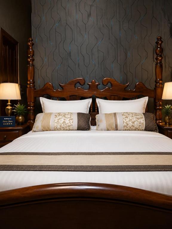 a bedroom with a large bed with two pillows at Oundo LVHAR in Busia