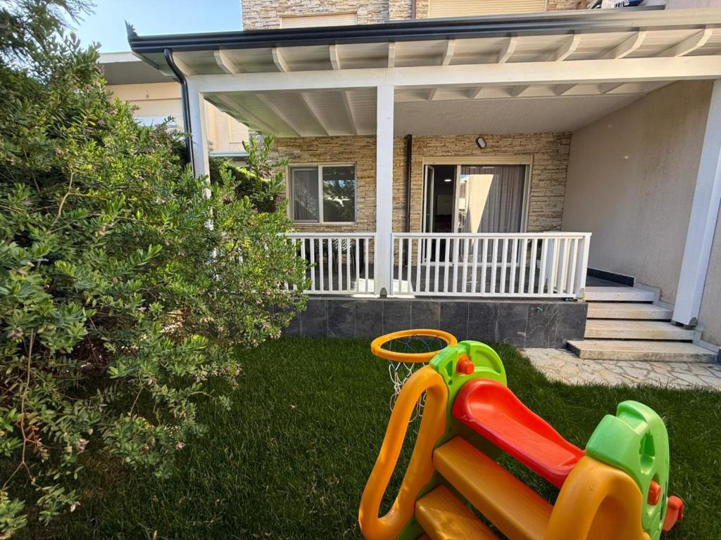 a house with a slide in the yard at Beach Garden Home, Lalzi Bay in Draç