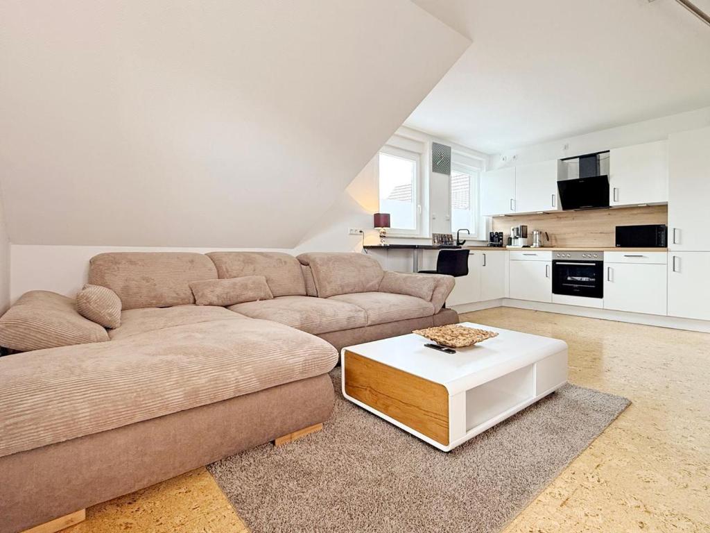 a living room with a couch and a coffee table at Am Berg und See in Stemwede