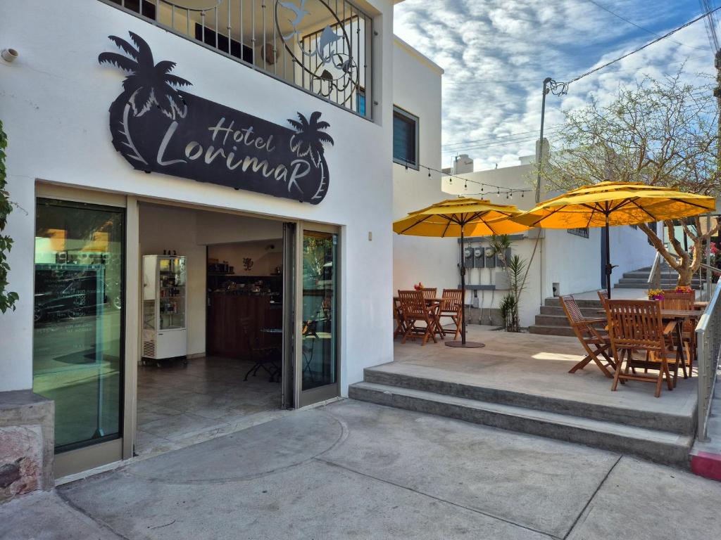 a restaurant with tables and umbrellas outside of it at Hotel Lorimar in La Paz