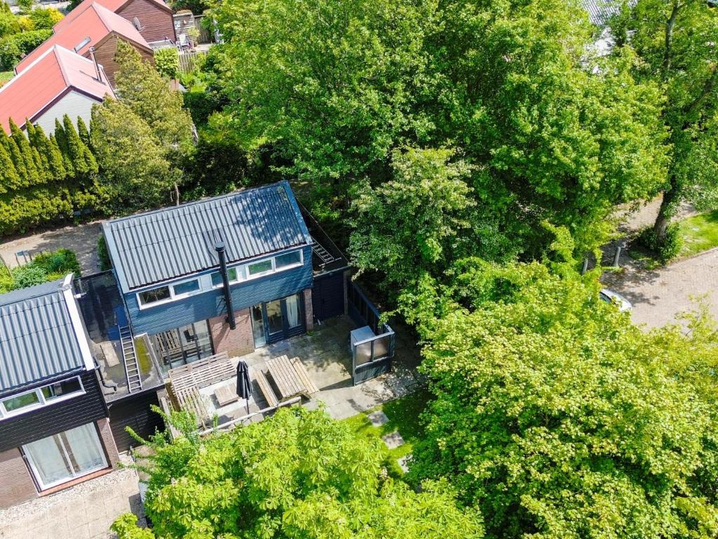 an overhead view of a blue house with trees at De Nordic Escape in Warmenhuizen