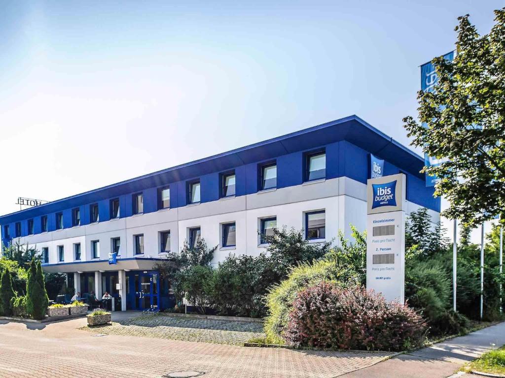 a blue and white building with a sign in front of it at ibis budget Augsburg Gersthofen in Augsburg