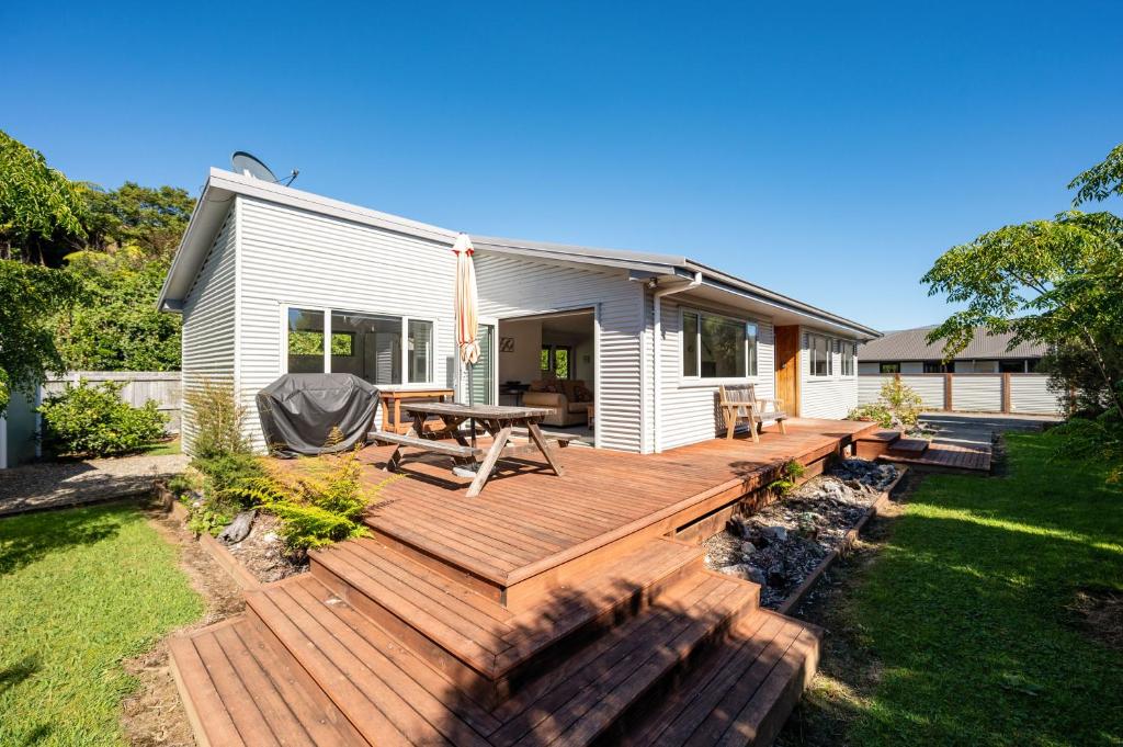 a wooden deck in front of a house at Pohara Retreat in Pohara