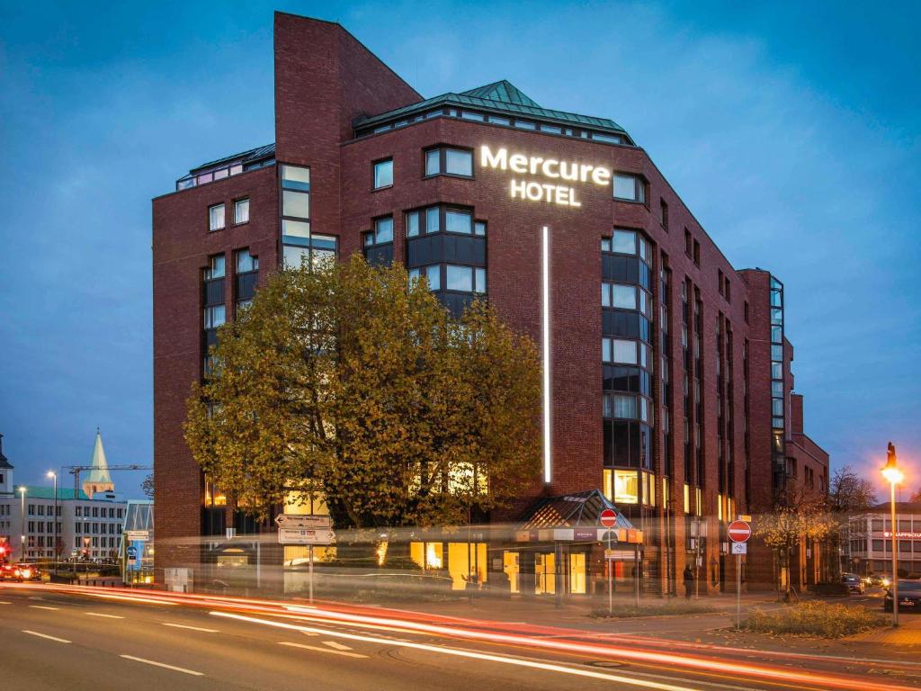 a large brick building with a mexico hotel sign on it at Mercure Hotel Hamm in Hamm