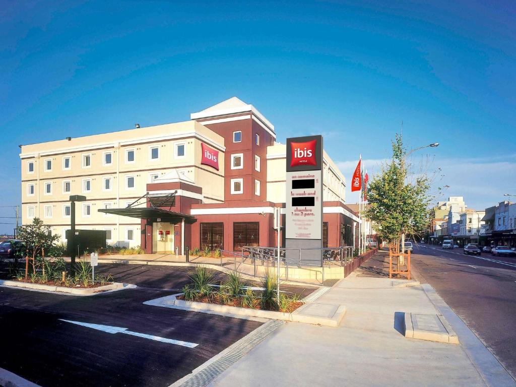 a building with a sign on the side of a street at ibis Newcastle in Newcastle