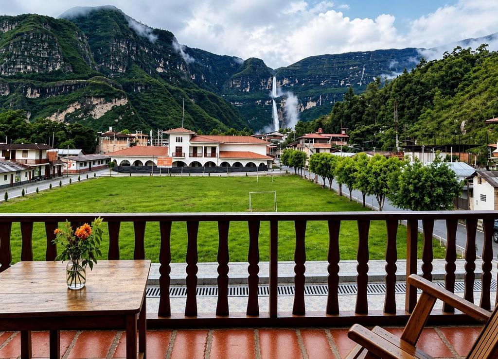 a balcony with a table and a view of a waterfall at Balcon de Gocta in Cocachimba