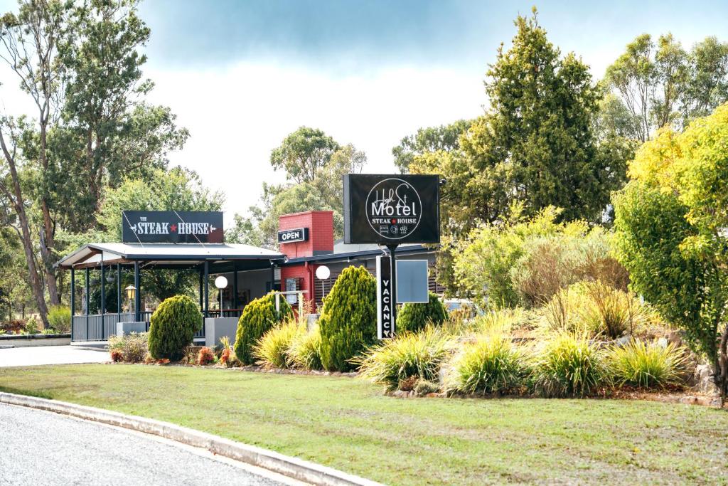 a sign in front of a building at High Street Motor Inn & Steakhouse in Stanthorpe