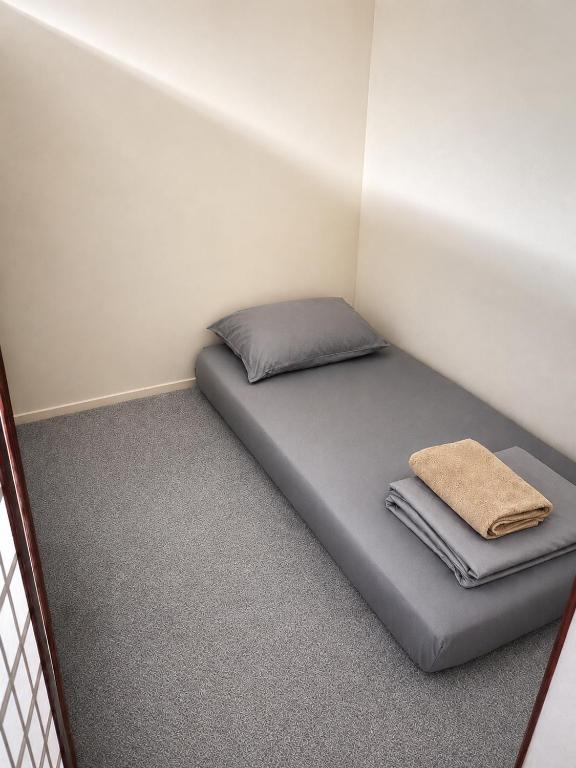 a small room with a bed in the corner at The Woodbox Hostel in Rawalpindi
