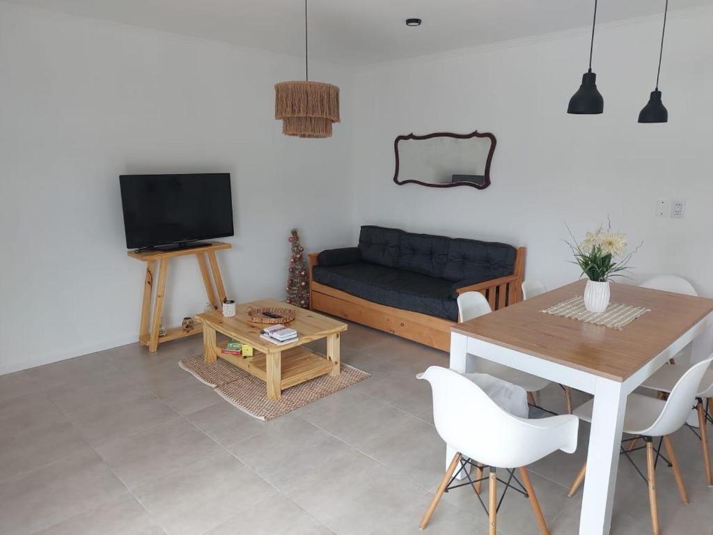 a living room with a couch and a table at Las moras quinta in San Nicolás de los Arroyos
