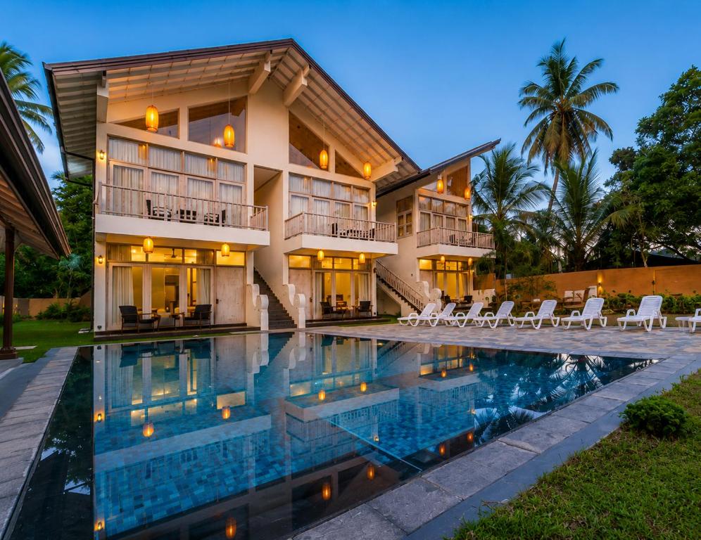 an exterior view of a house with a swimming pool at The Oceans Edge in Dodanduwa