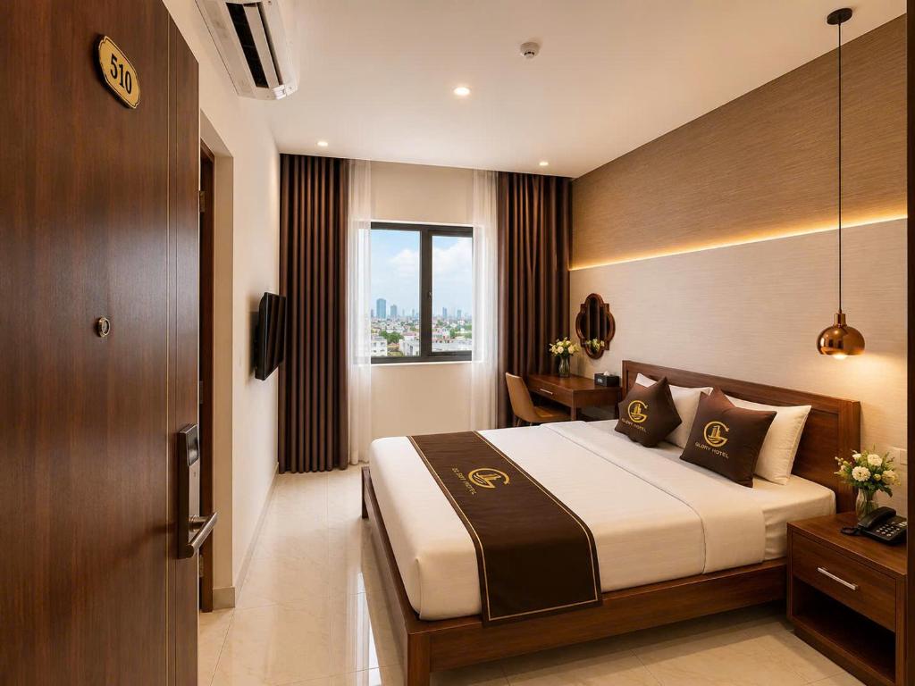a hotel room with a bed and a window at Glory Hotel in Can Tho