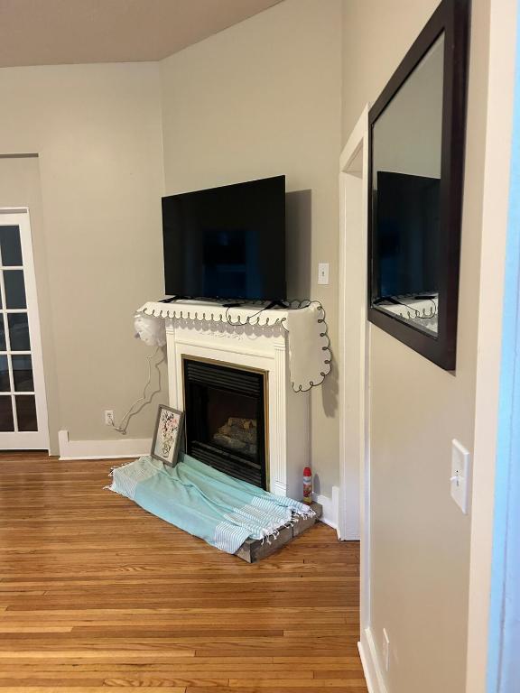 a living room with a fireplace and a tv at Robinsdale on broadway in Minneapolis